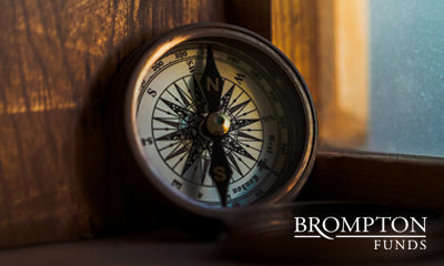 Brass compass on a wooden surface by a window, with the Brompton Funds logo in the corner, symbolizing guidance.